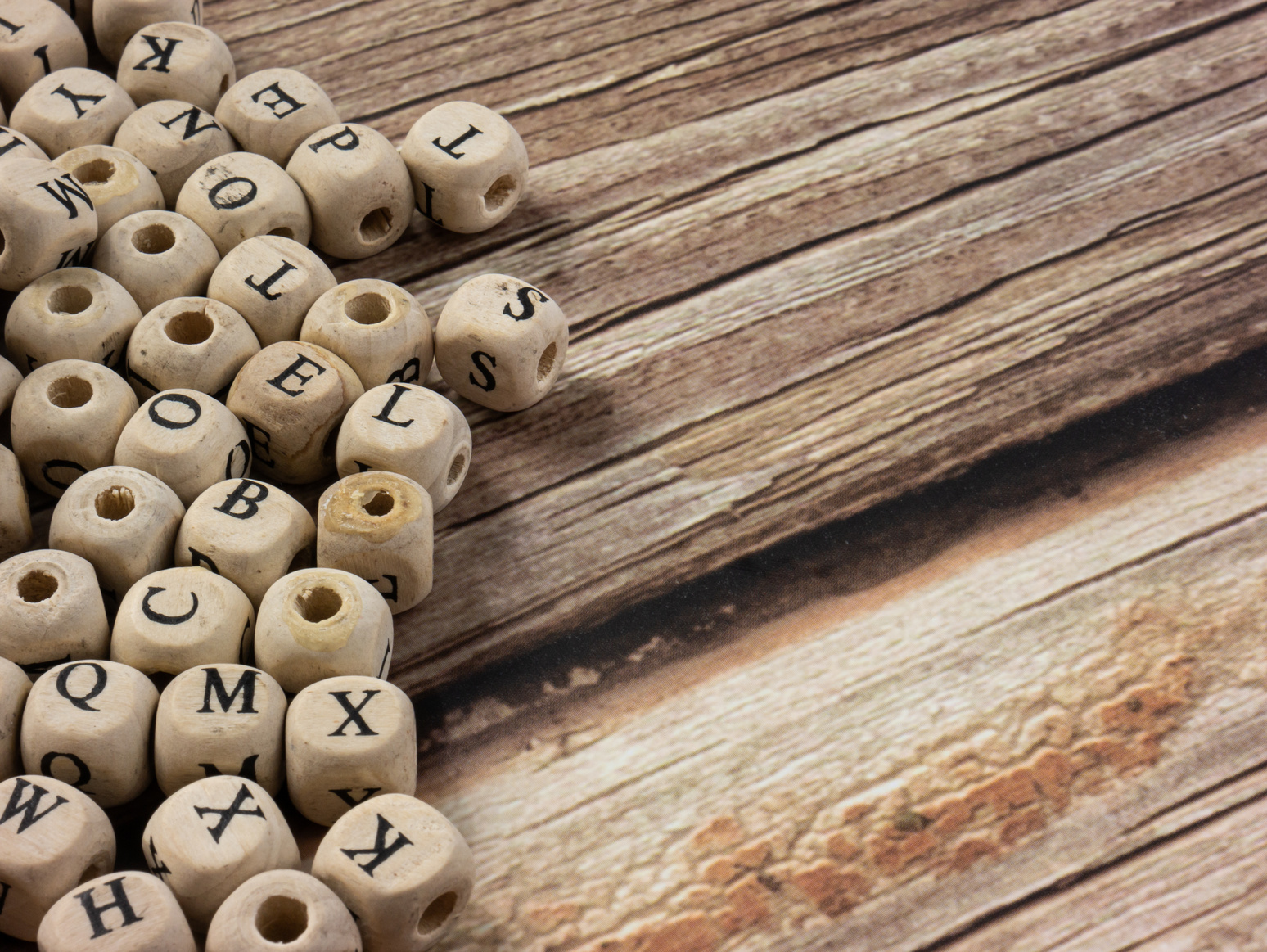 Wooden Alphabet Beads on Wooden Table 